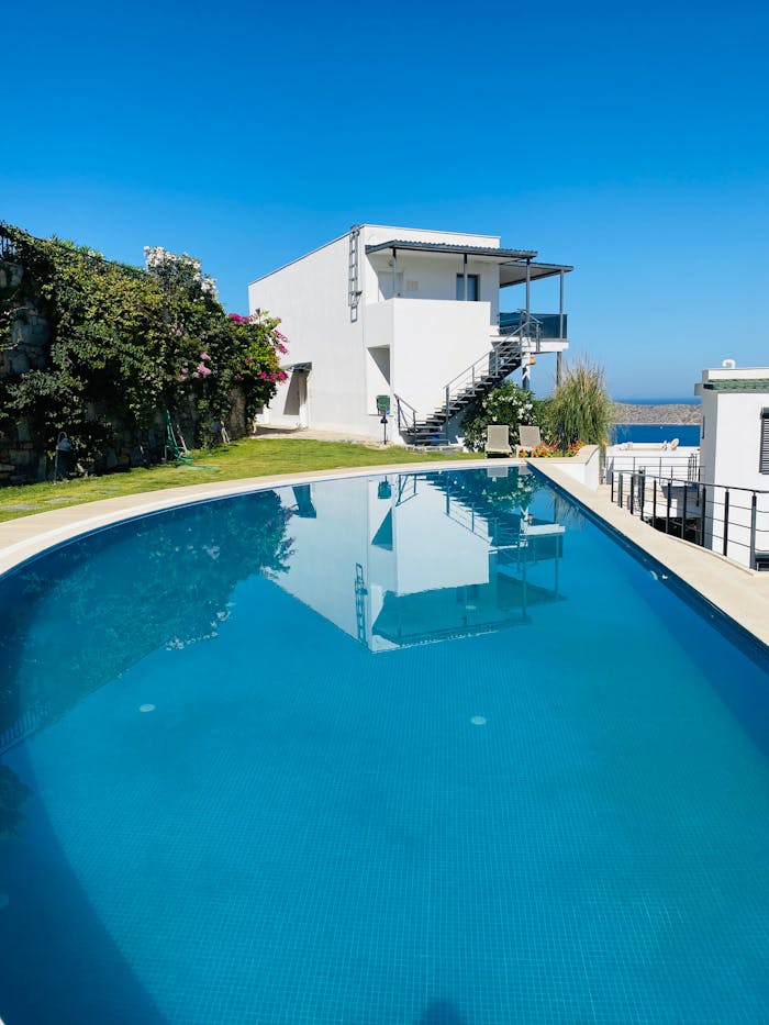 Elegant villa overlooking a stunning infinity pool with serene ocean views.